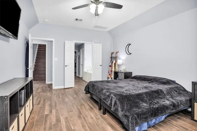 a bedroom with a bed and a chandelier