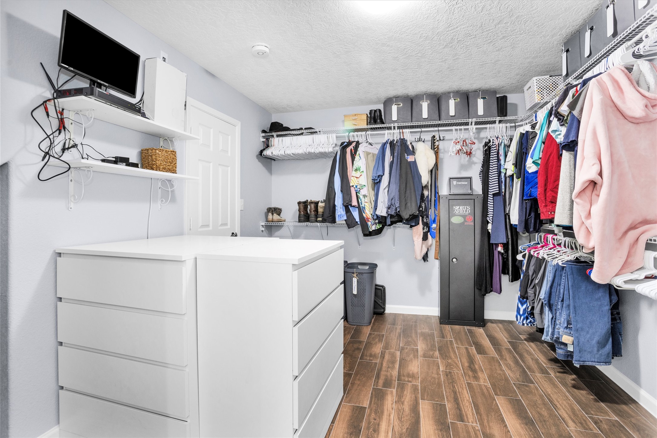 1057 Magnolia Point Drive Huffman, TX 77336 - Photo 32 of 48 THe primary closet is very spacious with lots of drawer space & overhead storage