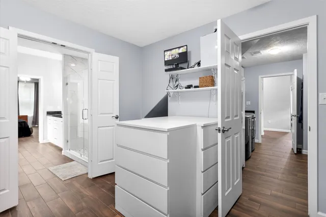 a view of hallway with wooden floor