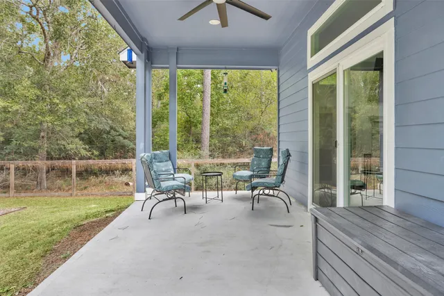 a view of a patio with a table chairs and backyard