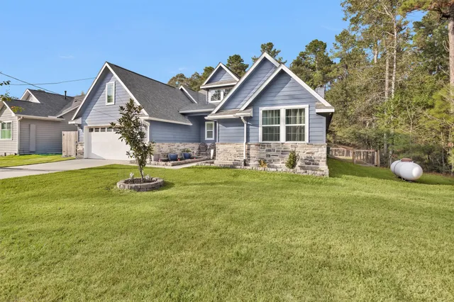 a front view of house with yard and green space