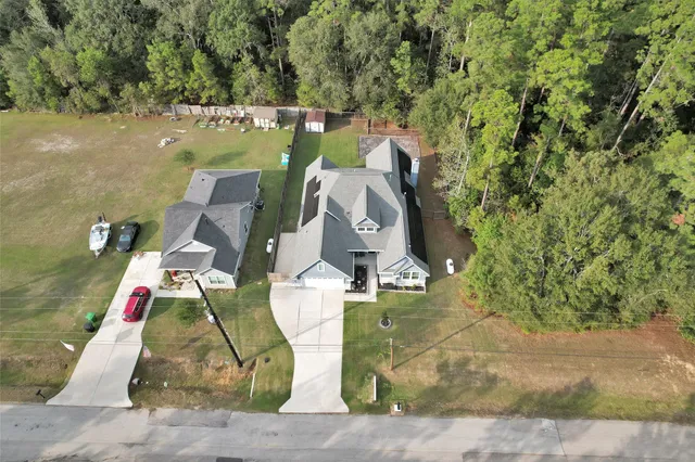 an aerial view of a house with a yard and staircase