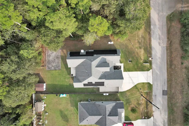 an aerial view of a house with outdoor space