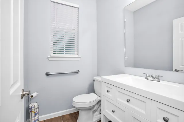 a bathroom with a sink toilet and vanity