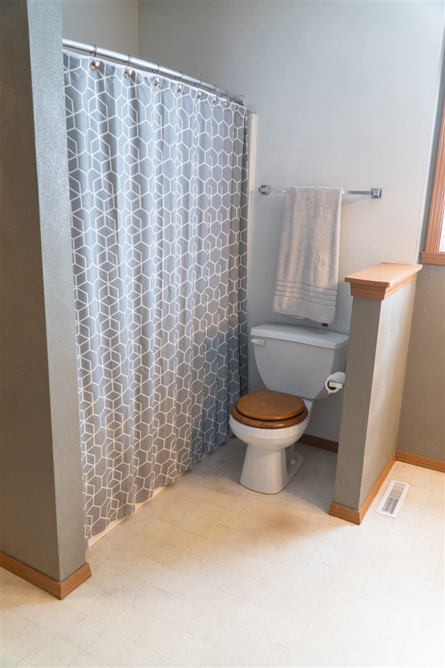 696 Bayfield Road Rockton, IL 61072 - Photo 16 of 20 a bathroom with a toilet and a shower curtain
