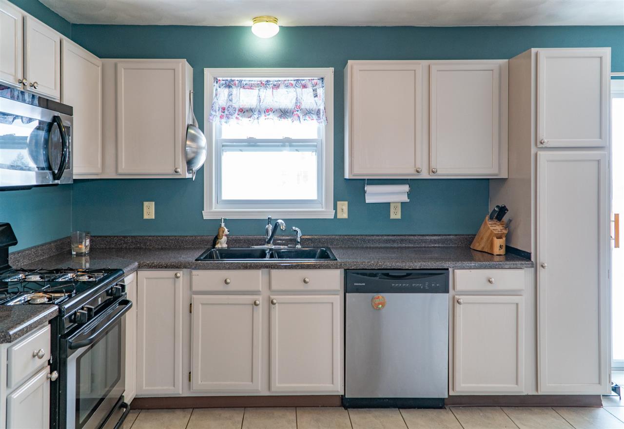696 Bayfield Road Rockton, IL 61072 - Photo 7 of 20 a kitchen with stainless steel appliances granite countertop a stove and a refrigerator