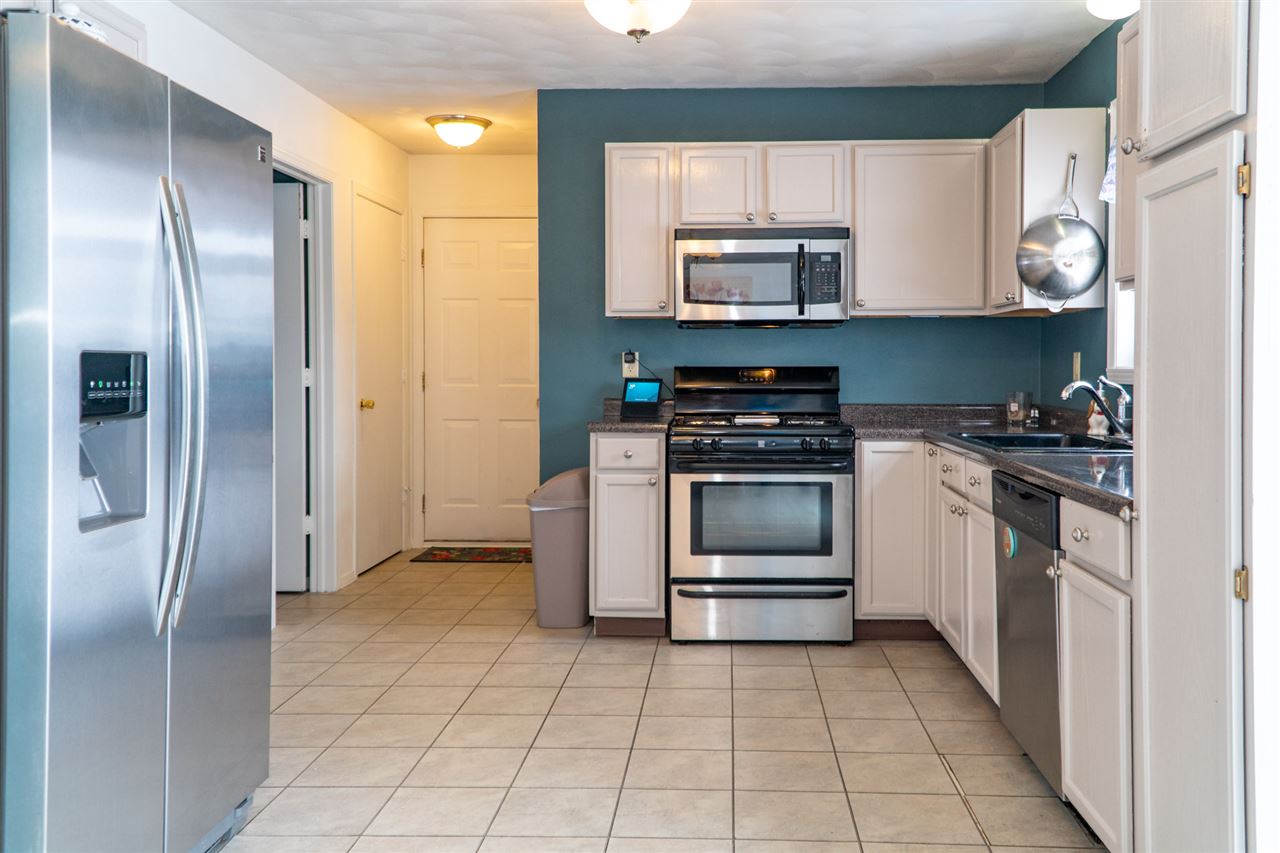 696 Bayfield Road Rockton, IL 61072 - Photo 10 of 20 a kitchen with white cabinets and stainless steel appliances