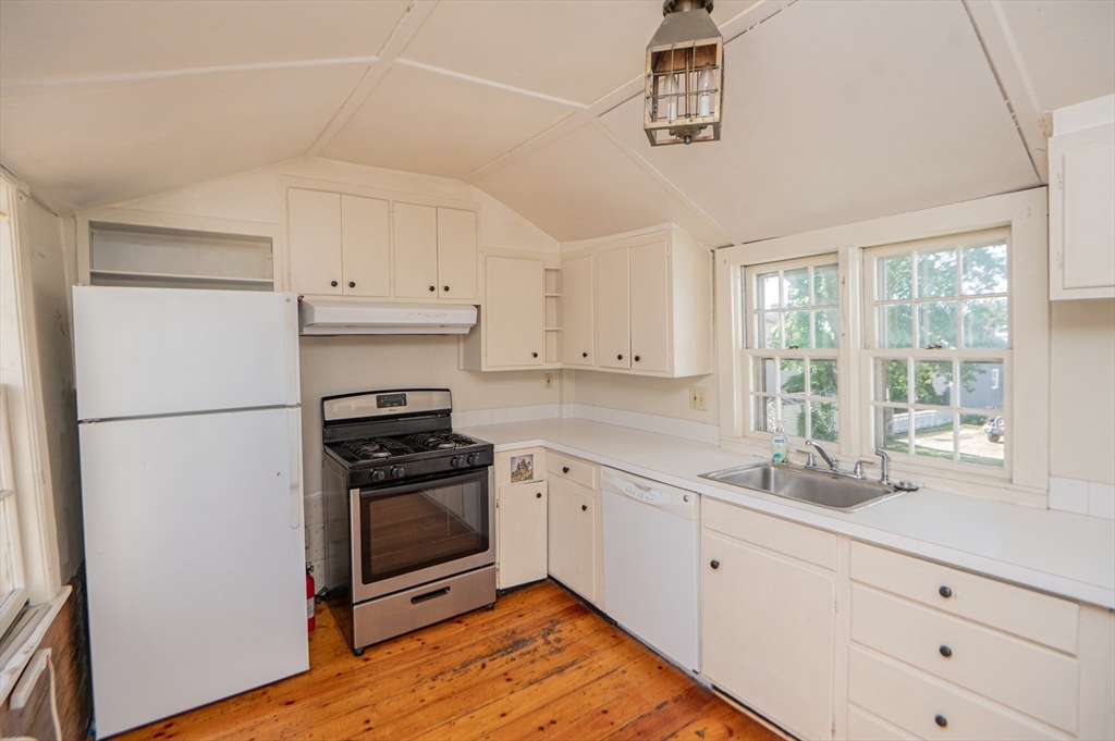 6 Merritt Street Marblehead, MA 01945 - Photo 11 of 31 a kitchen with granite countertop white cabinets and white appliances