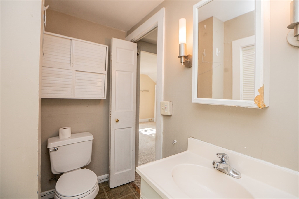 6 Merritt Street Marblehead, MA 01945 - Photo 15 of 31 a bathroom with a toilet a sink and mirror