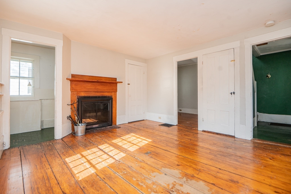 6 Merritt Street Marblehead, MA 01945 - Photo 5 of 31 a view of empty room with a fireplace and wooden floor