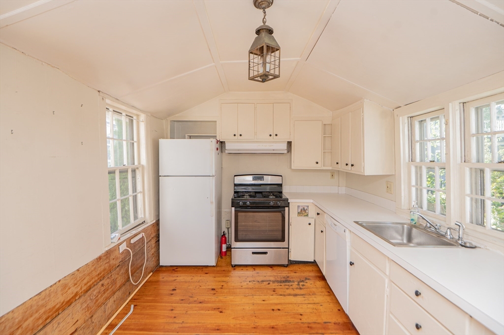 6 Merritt Street Marblehead, MA 01945 - Photo 8 of 31 a kitchen with granite countertop a sink stainless steel appliances and cabinets