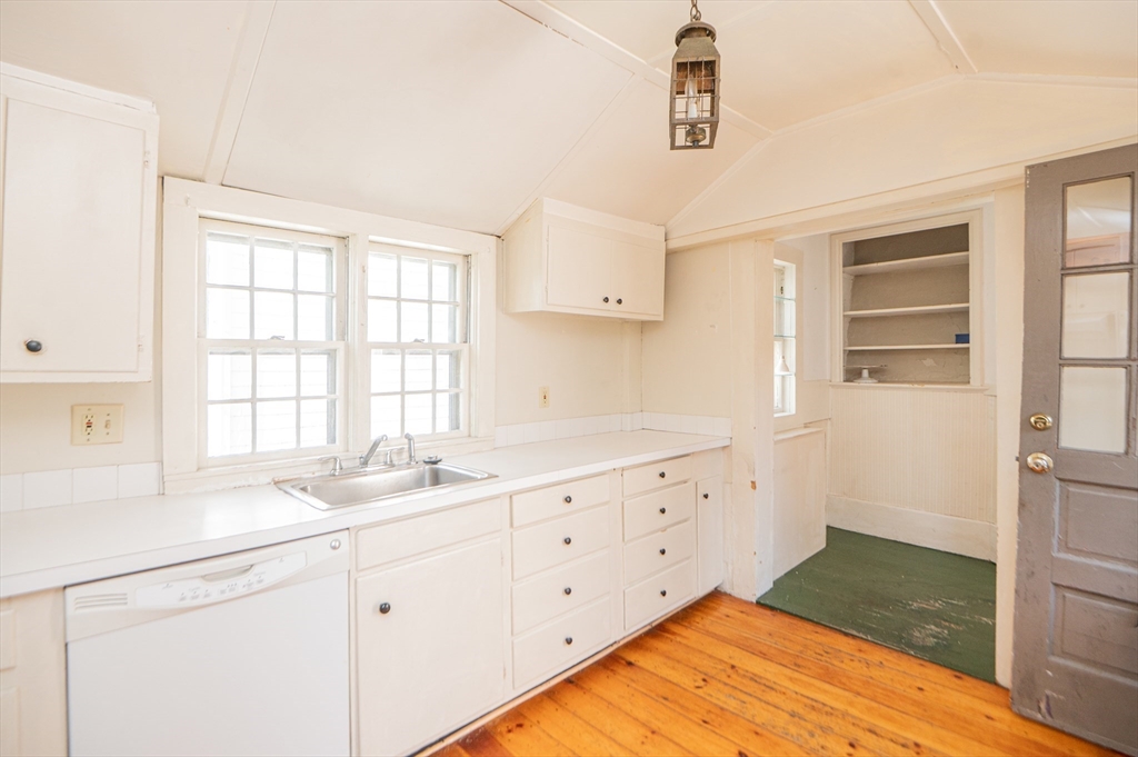 6 Merritt Street Marblehead, MA 01945 - Photo 9 of 31 a kitchen with granite countertop a sink window and cabinets