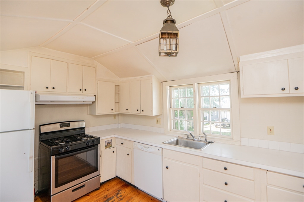 6 Merritt Street Marblehead, MA 01945 - Photo 10 of 31 a kitchen with stainless steel appliances a sink stove and cabinets