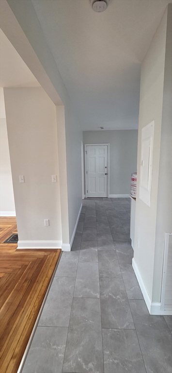 25 Bennett Street, Unit 2 Beverly, MA 01915 - Photo 4 of 17 an empty room with windows