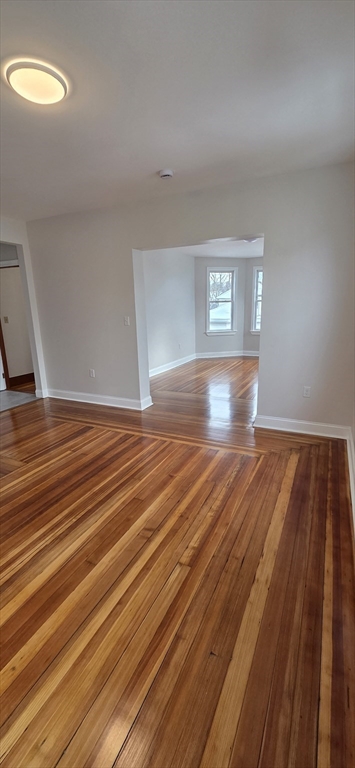 25 Bennett Street, Unit 2 Beverly, MA 01915 - Photo 6 of 17 a view of empty room with window and wooden floor