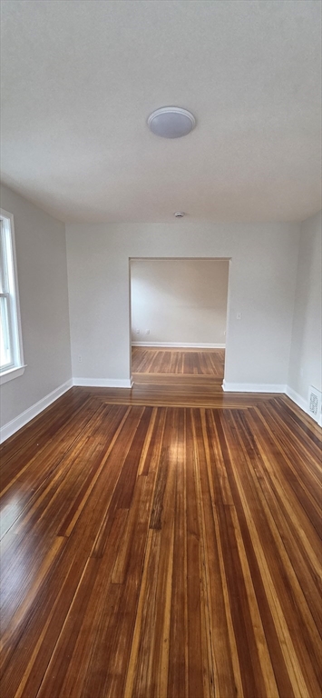 25 Bennett Street, Unit 2 Beverly, MA 01915 - Photo 9 of 17 a view of empty room with wooden floor