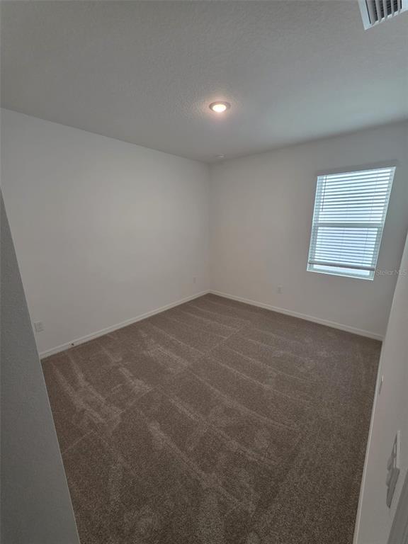 6008 Vision Road St. Cloud, FL 34771 - Photo 13 of 33 an empty room with windows