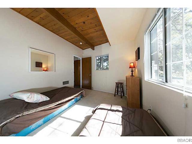 26652 Valley View Lake Rimforest, CA 92378 - Photo 9 of 17 a bedroom with a bed and wooden floor