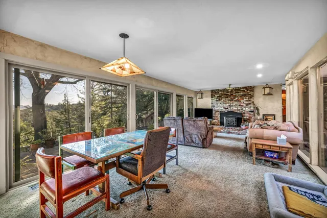 a living room with furniture and a floor to ceiling window