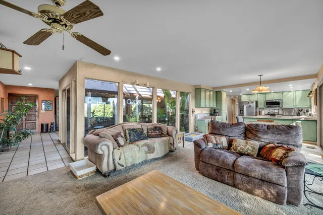 a view of a livingroom with workspace and a window