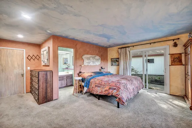 a view of backyard with wooden fence