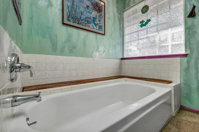 a view of a chair and table in backyard of the house