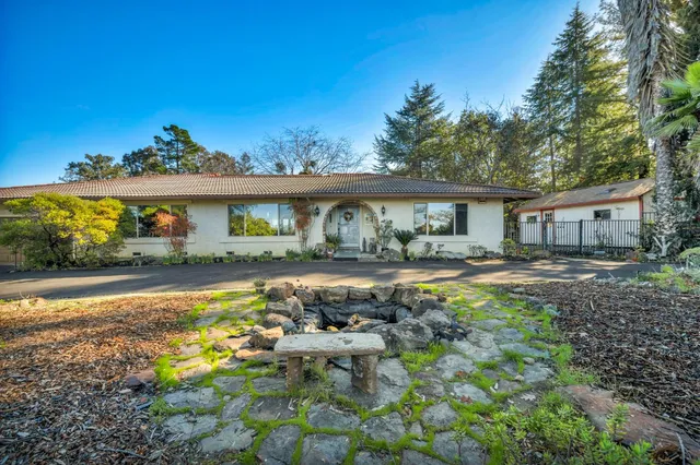 a front view of a house with garden