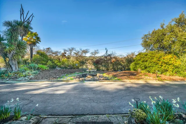 a front view of a house with swimming pool and sitting area