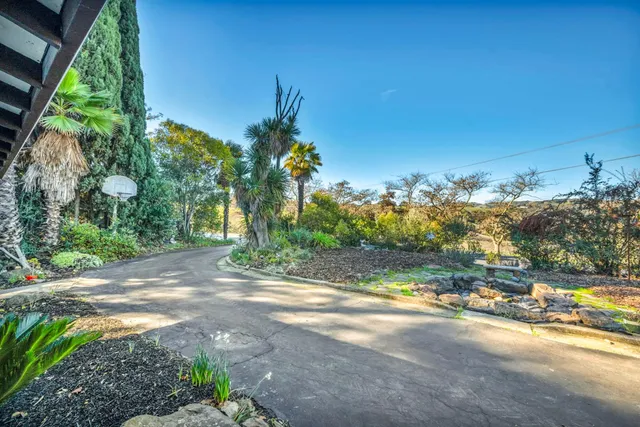 a backyard of a house with yard and outdoor seating