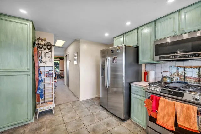 a dining room with furniture and a kitchen view