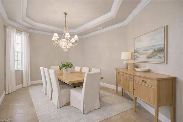 a dining room with furniture a livingroom and chandelier