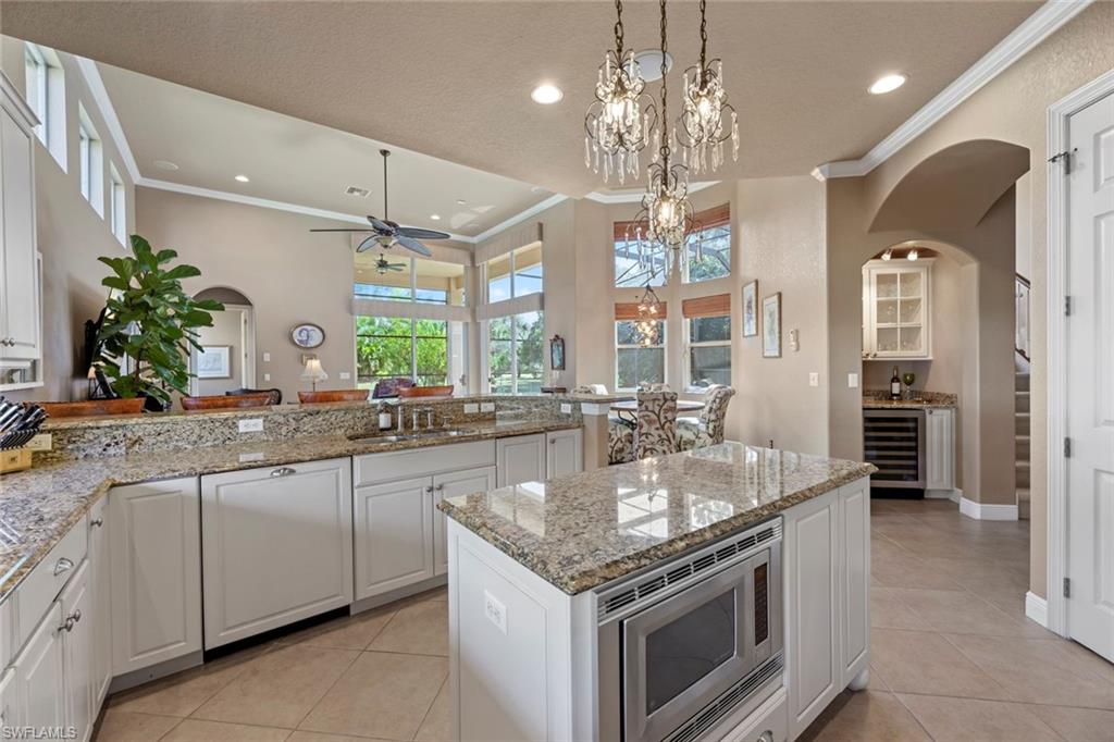 19260 La Serena Drive Estero, FL 33967 - Photo 14 of 48 a kitchen with stainless steel appliances granite countertop a sink and stove