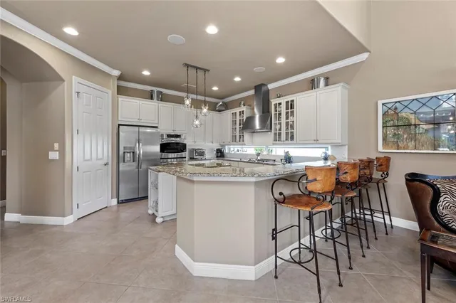 a kitchen with stainless steel appliances kitchen island granite countertop a sink and cabinets