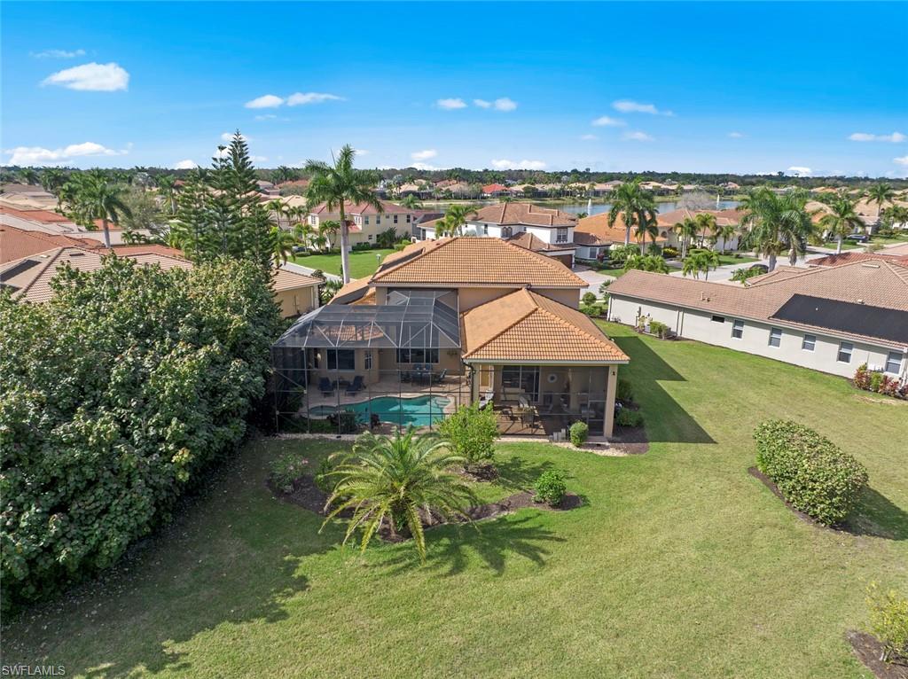 19260 La Serena Drive Estero, FL 33967 - Photo 2 of 48 a aerial view of a house with a garden and lake view
