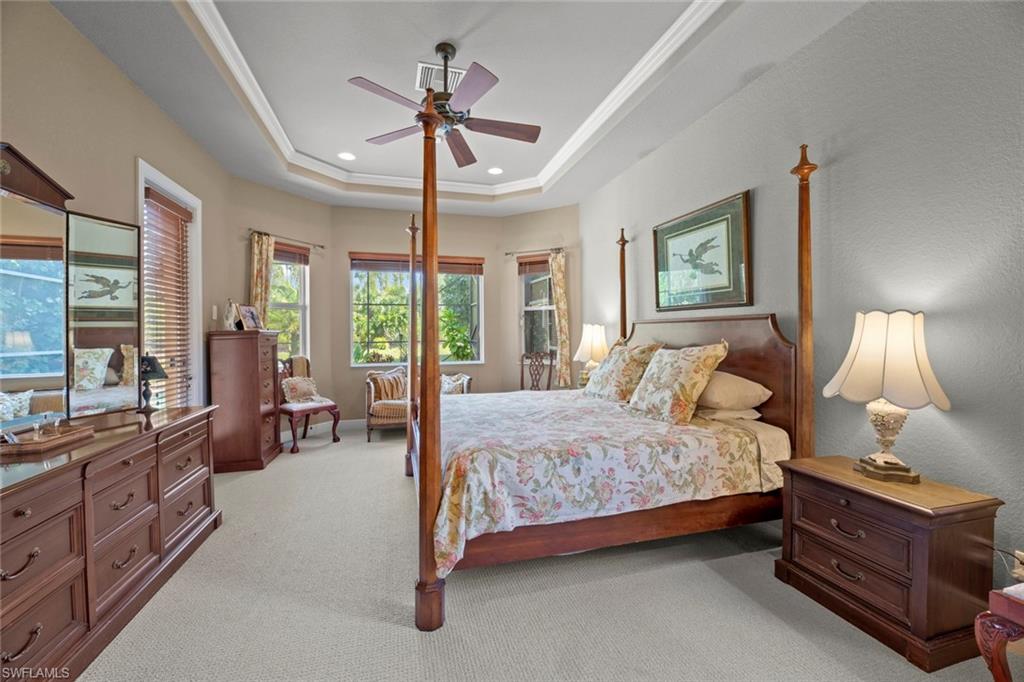 19260 La Serena Drive Estero, FL 33967 - Photo 27 of 48 a bedroom with a bed a chandelier and large windows