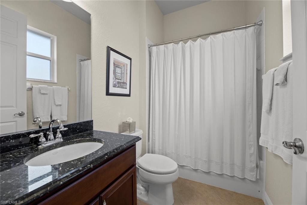 19260 La Serena Drive Estero, FL 33967 - Photo 31 of 48 a bathroom with a granite countertop sink and a mirror