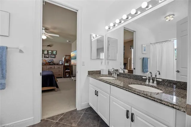 a spacious bathroom with a granite countertop sink mirror and double