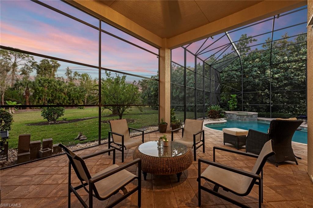 19260 La Serena Drive Estero, FL 33967 - Photo 44 of 48 a view of chairs and table in patio with a yard