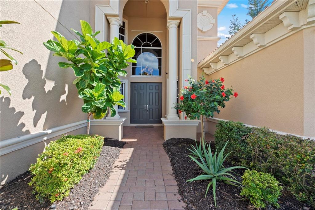 19260 La Serena Drive Estero, FL 33967 - Photo 5 of 48 a front view of a house with a yard