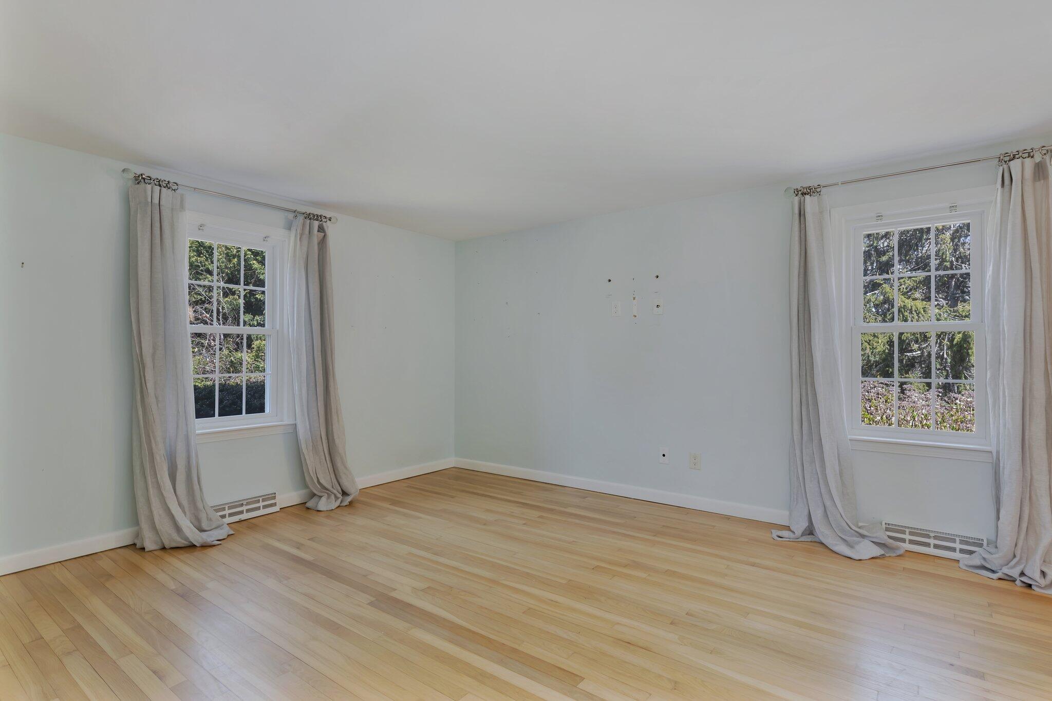 248 Chippingstone Road Chatham, MA 02633 - Photo 14 of 26 an empty room with wooden floor and windows