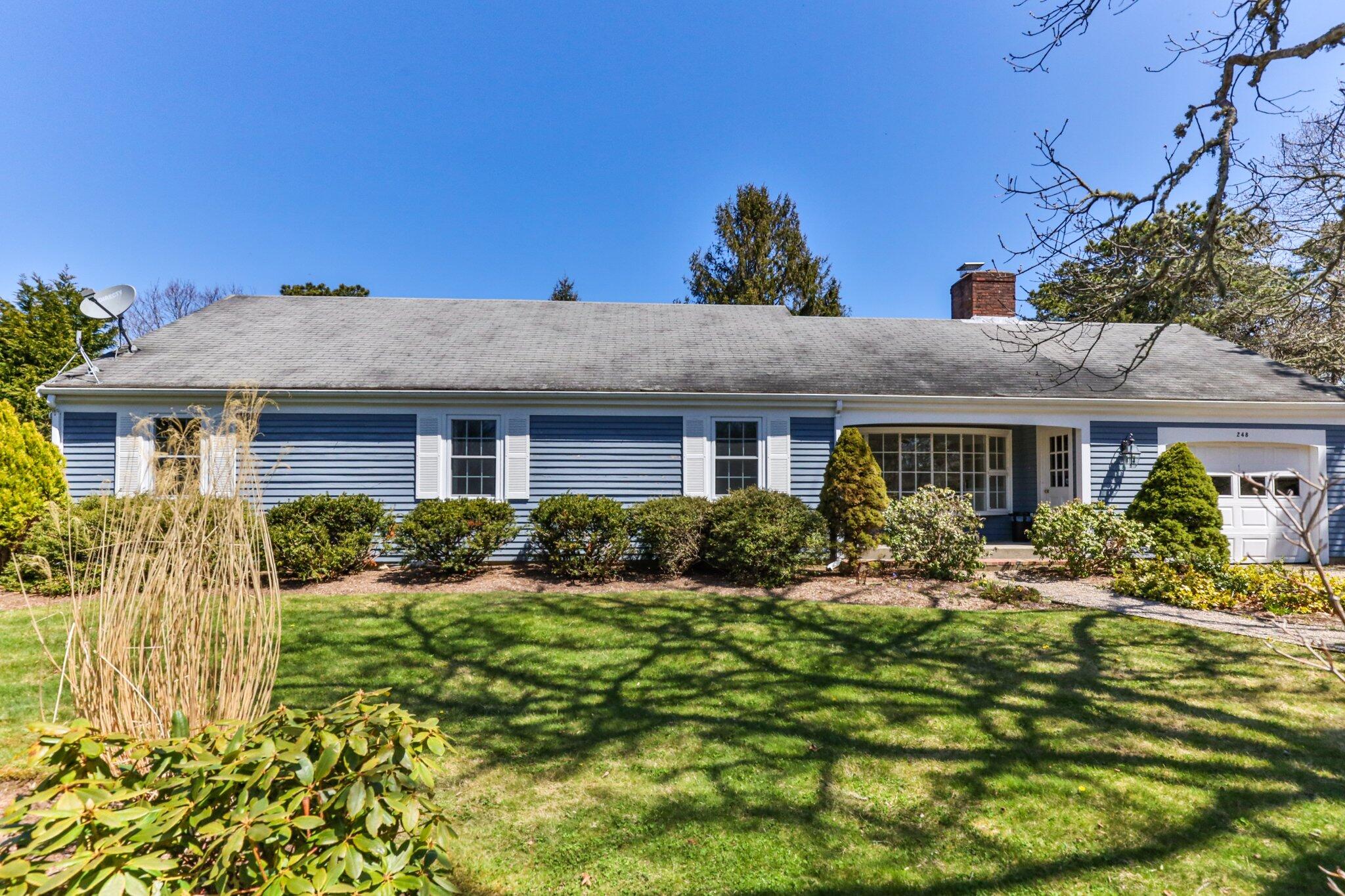 248 Chippingstone Road Chatham, MA 02633 - Photo 2 of 26 a front view of a house with a yard