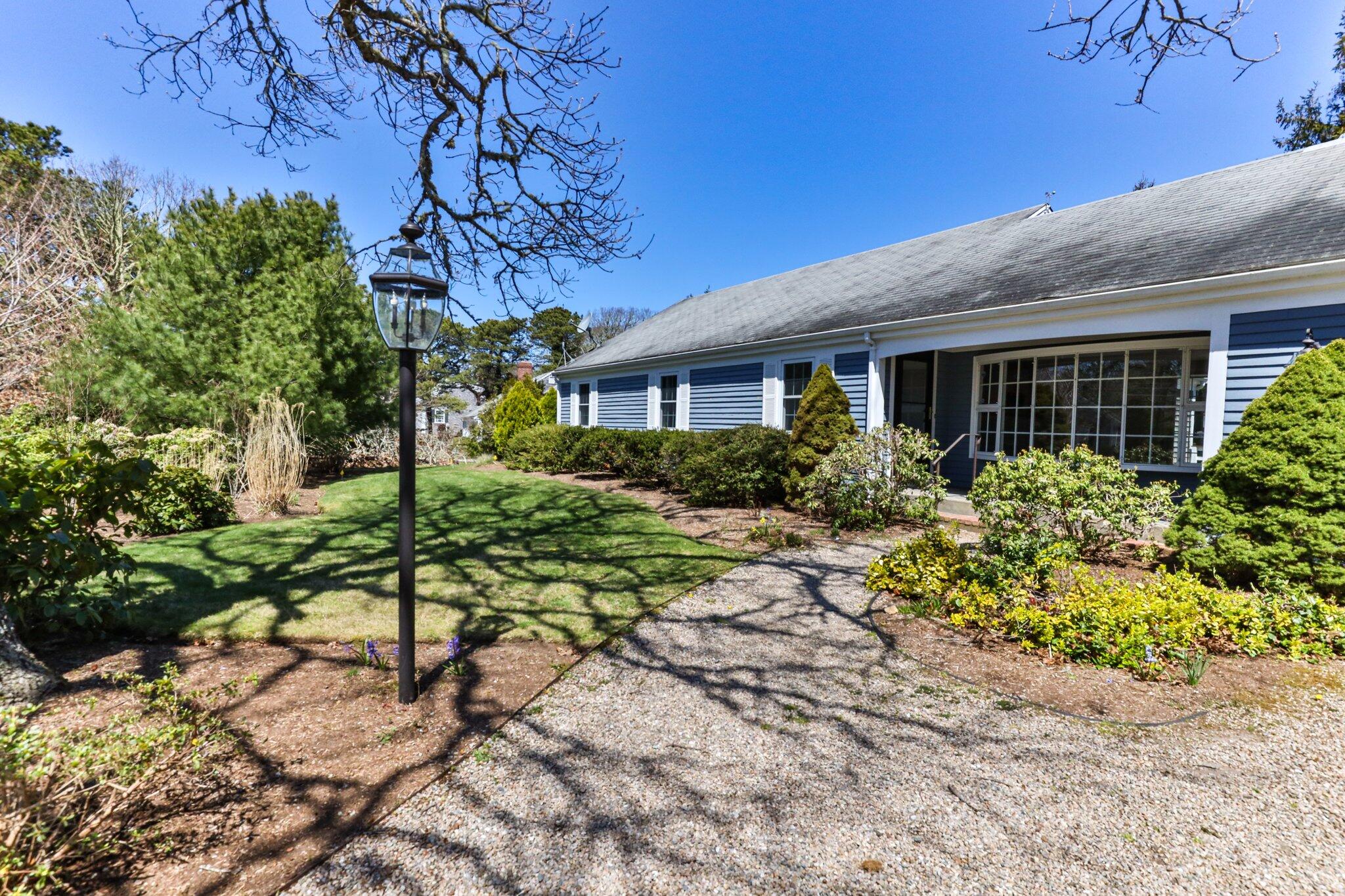 248 Chippingstone Road Chatham, MA 02633 - Photo 3 of 26 a flower garden is sitting in front of a house