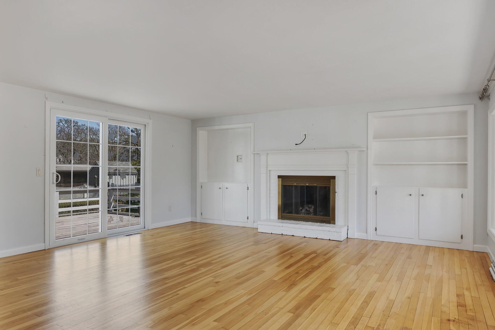 248 Chippingstone Road Chatham, MA 02633 - Photo 4 of 26 a view of an empty room with wooden floor and a window