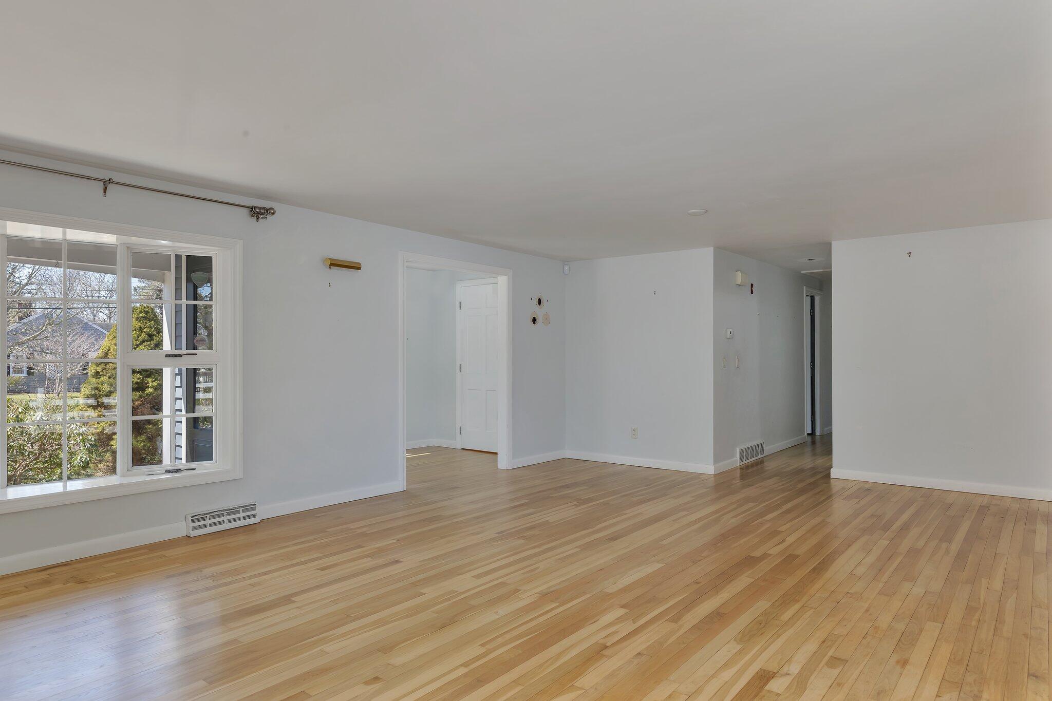 248 Chippingstone Road Chatham, MA 02633 - Photo 5 of 26 a view of an empty room with wooden floor and a window
