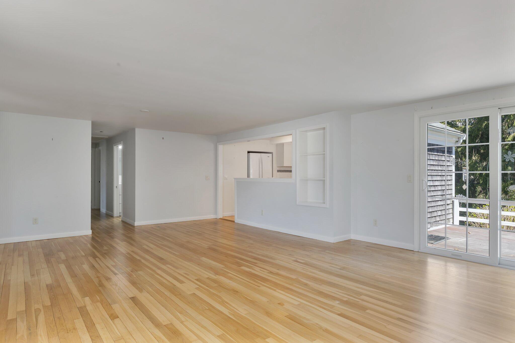 248 Chippingstone Road Chatham, MA 02633 - Photo 6 of 26 a view of an empty room with wooden floor and a window