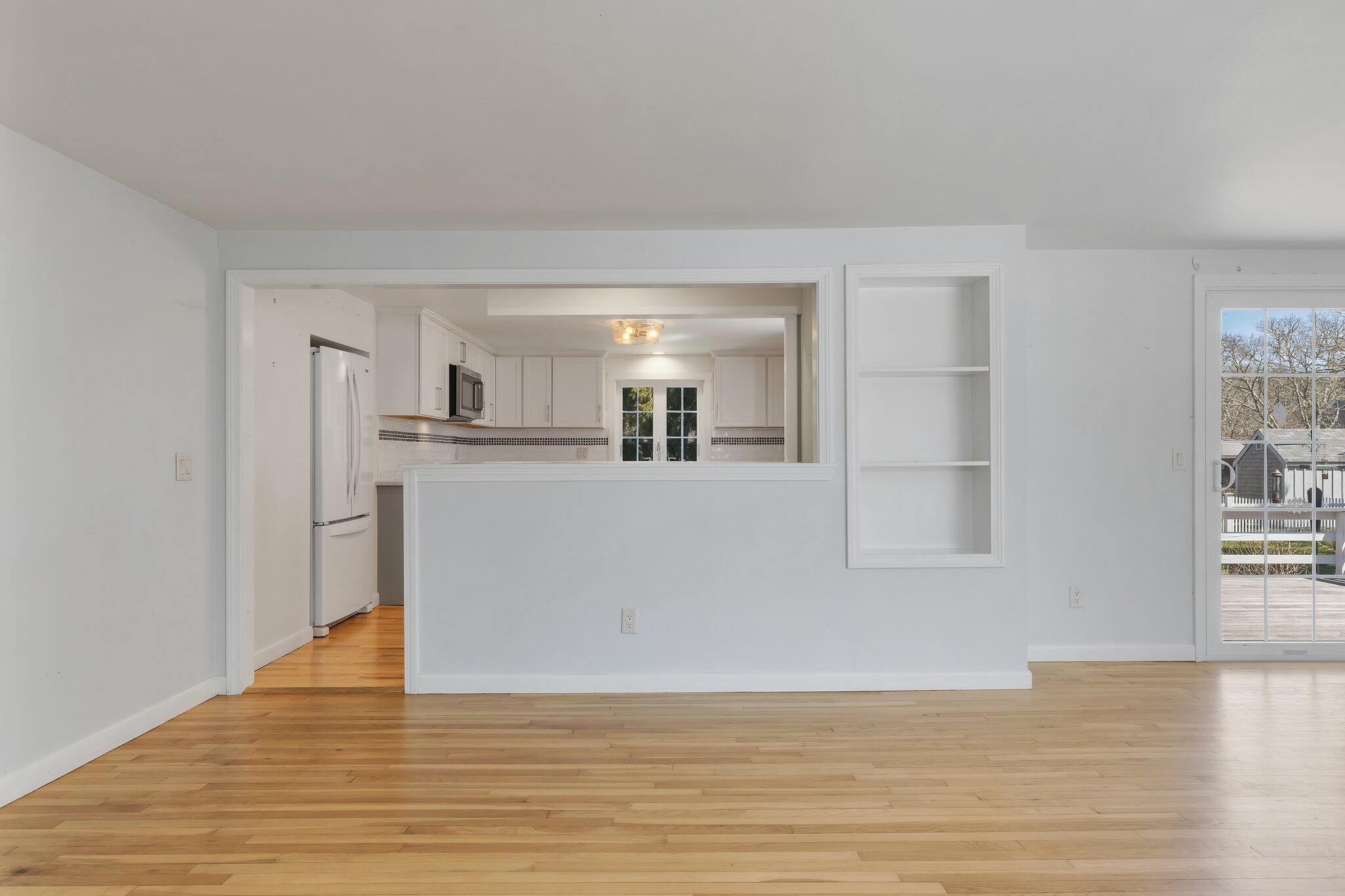 248 Chippingstone Road Chatham, MA 02633 - Photo 7 of 26 a view of a kitchen with wooden floor and a window