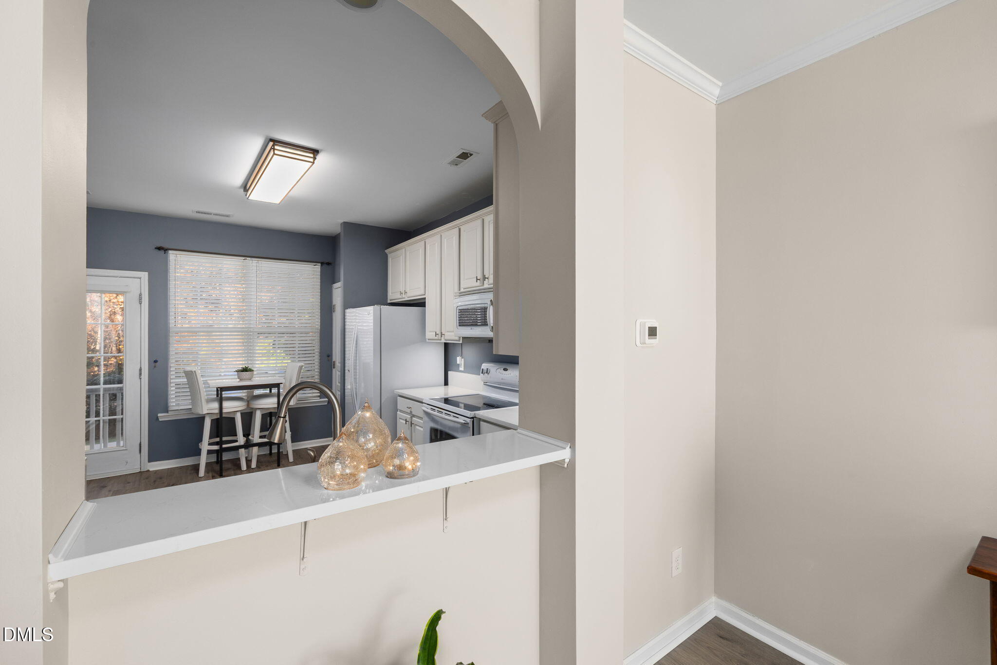 4424 Sugarbend Way Raleigh, NC 27606 - Photo 13 of 38 a view of a kitchen from the hallway