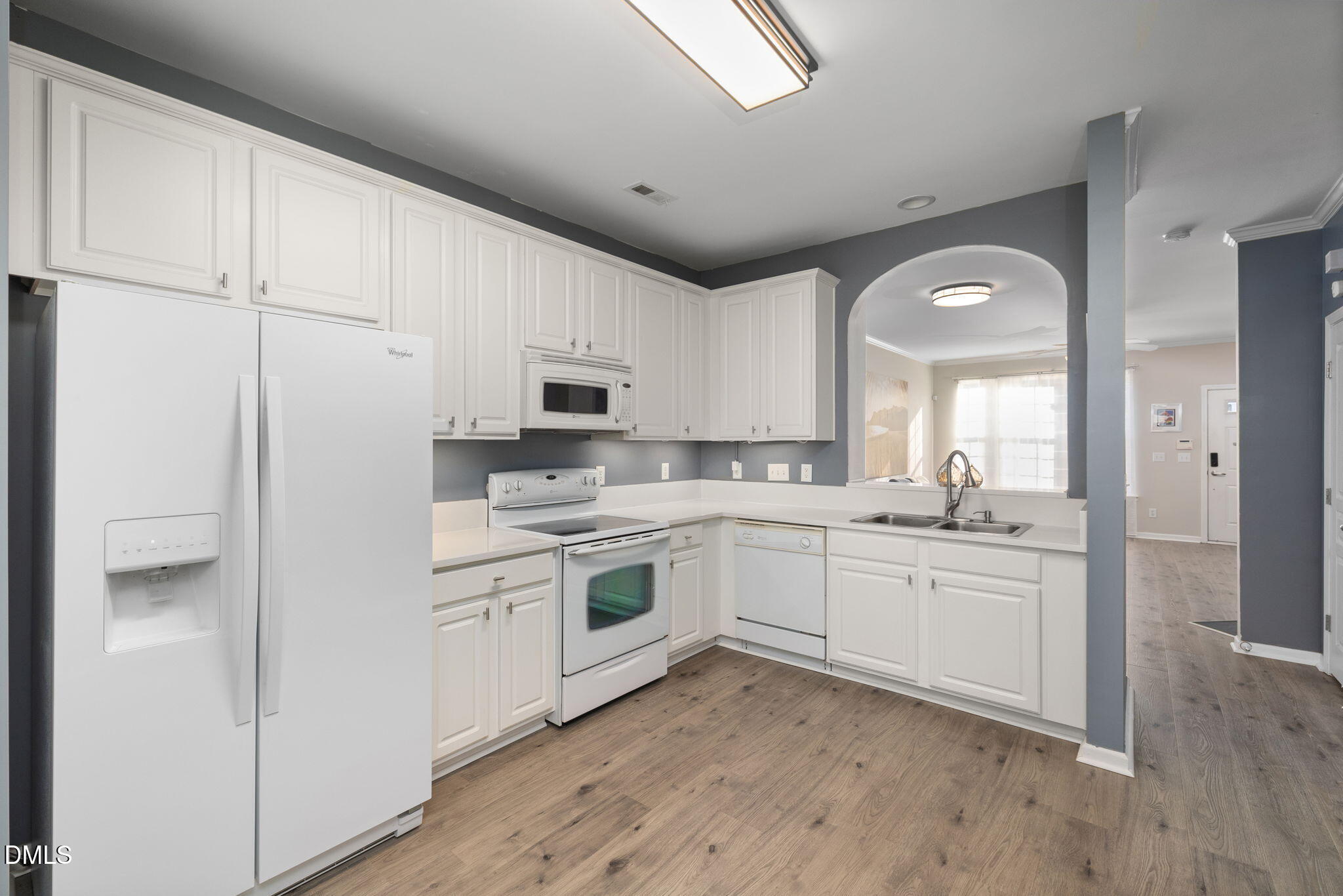 4424 Sugarbend Way Raleigh, NC 27606 - Photo 15 of 38 a kitchen with white cabinets and white appliances