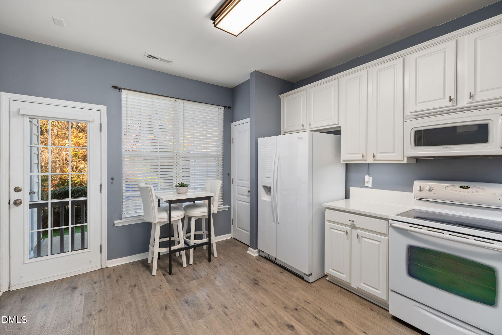 4424 Sugarbend Way Raleigh, NC 27606 - Photo 17 of 38 a kitchen with wooden cabinets and white appliances