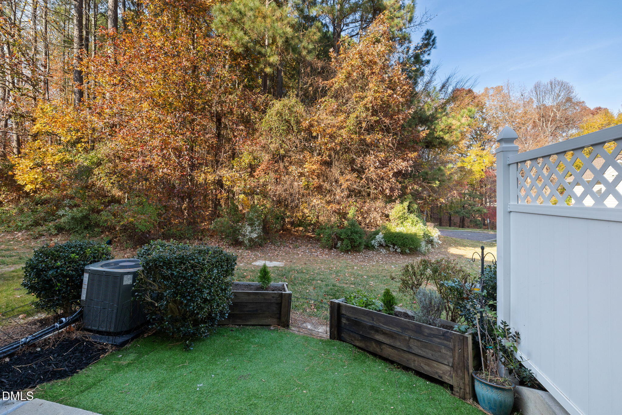 4424 Sugarbend Way Raleigh, NC 27606 - Photo 31 of 38 a view of a backyard with wooden fence and a bench